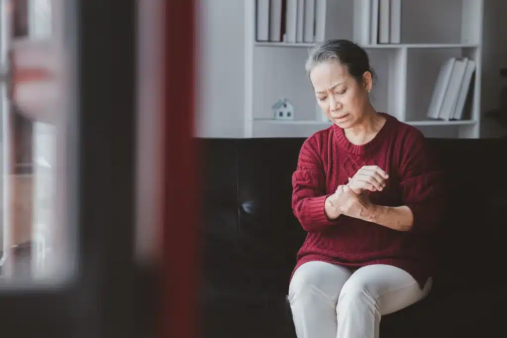 Elderly woman living independently at home with a personal alarm watch